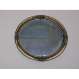 A Victorian gilt wood and gesso wall mirror, with oval plate, 45cm x 40cm. (AF)