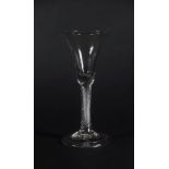 An 18thC wine glass, with bell shaped bowl and air twist stem on a folded foot, 18.3cm high.
