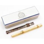 An early 19thC worked ivory ink pen, with gold banded floral decoration, with turn screw cap and
