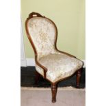 A Victorian walnut show frame spoon back chair, with a moulded frame upholstered in floral fabric on