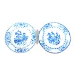 A pair of mid 18thC Chinese blue and white plates, decorated with flowers and foliage, 23cm