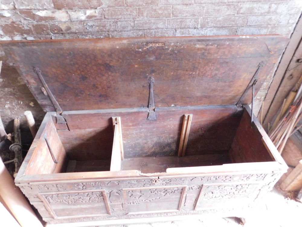 A large 17thC carved poker work walnut coffer, the lid with iron strap hinges and carved figural and - Image 3 of 4