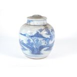 An 18th/19thC Chinese ginger jar and cover, decorated with a blue and white landscape, 24cm high.