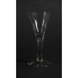 An 18thC wine glass, with trumpet bowl and tapered air stem, 16.5cm high.