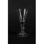 An 18thC wine glass, the plain thistle bowl with solid base and air mushroom knop to the stem, on