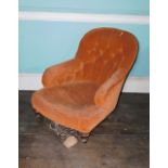 A Victorian walnut low deep seated armchair in the manner of Howard & Sons, upholstered in orange