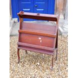 An Edwardian mahogany book and folio stand, with triangular end supports and slatted divisions on