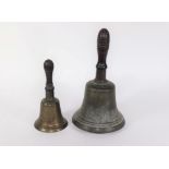 Two Victorian hand bells, with turned wooden handles, 28cm and 20.5cm respectively.