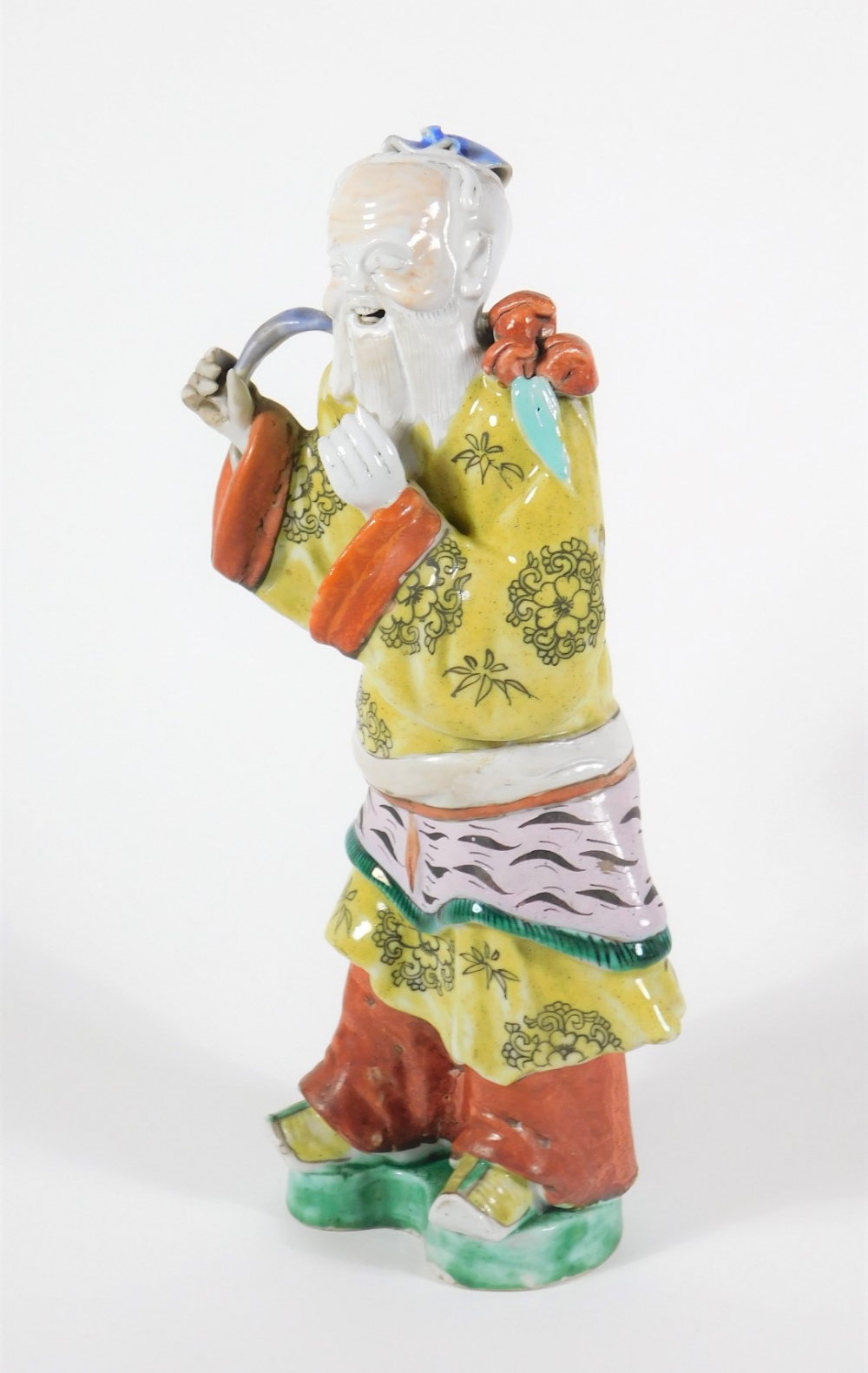 A 19thC Chinese polychrome porcelain figure of a bearded sage, dressed in a yellow robe, 27cm high. - Image 2 of 5