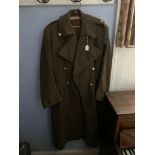 A British Army great coat, bearing Royal Artillery buttons, some moth damage.