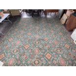 A large Axminster type carpet, with the design of medallions on a green ground, 236cm x 462cm.