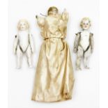 A 19thC miniature porcelain doll with satin dress, and two Victorian miniature jointed porcelain