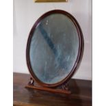 A Victorian mahogany easel frame mirror, with oval plate and moulded frame, 68cm high.