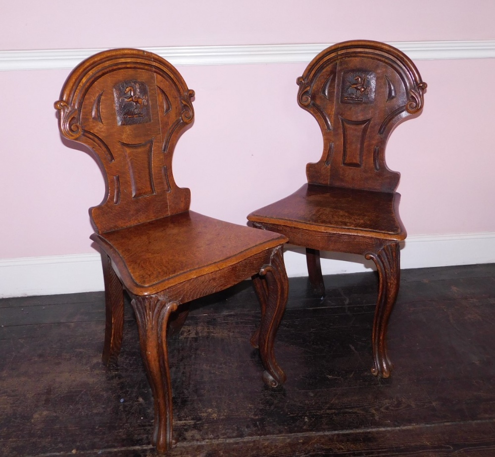 A pair Victorian oak hall chairs, the shield shaped back with carved Pegasus crest, the solid - Image 2 of 5