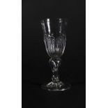 A late 17thC wine glass, with spiked gadrooning to the bowl and inverted air baluster stem on a