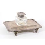 An Edwardian silver desk stand, of rectangular design with gadrooned border and foliate scroll