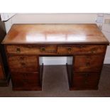 A 19thC mahogany kneehole desk or dressing table, the top with a moulded edge above an arrangement
