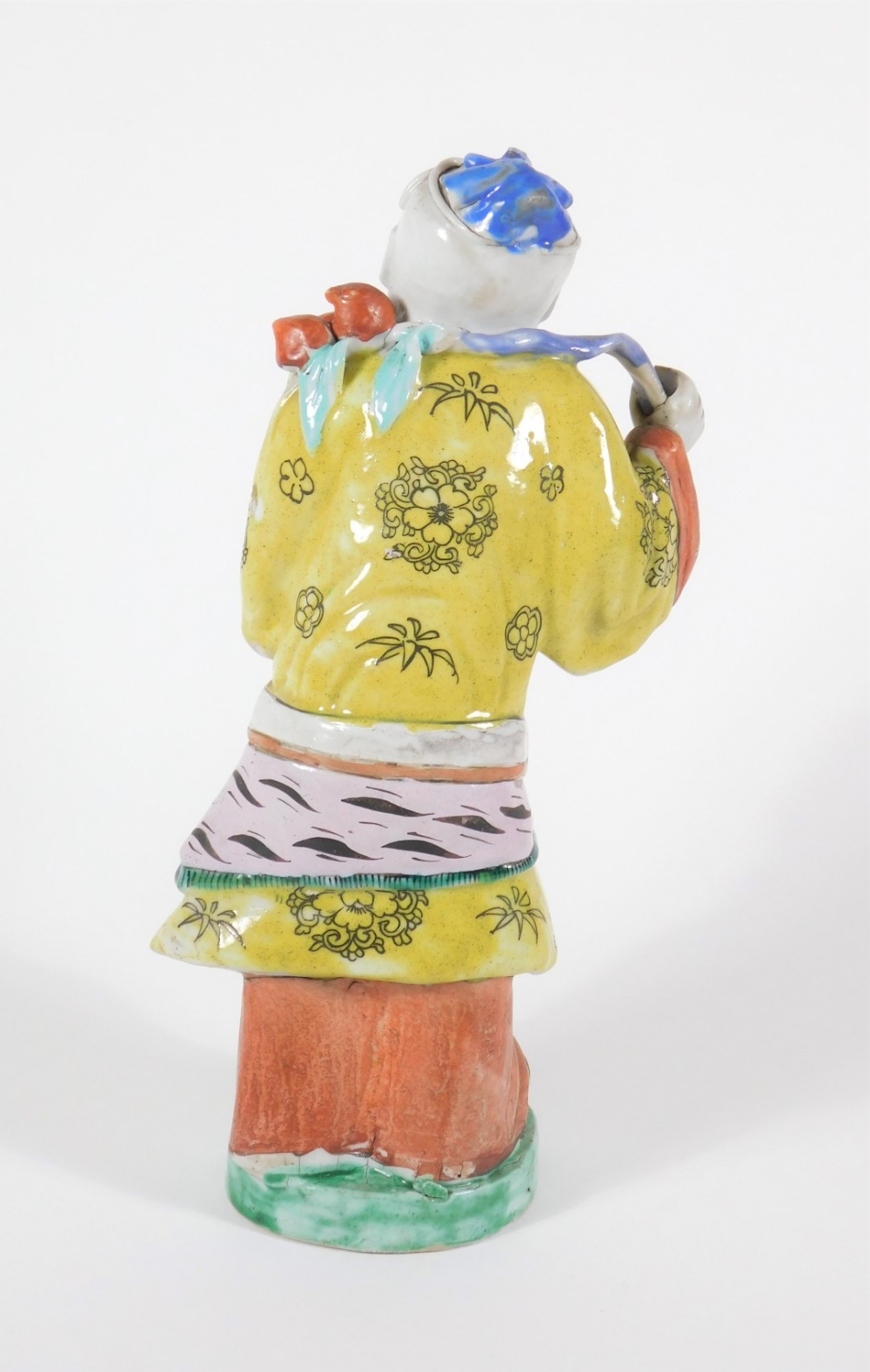 A 19thC Chinese polychrome porcelain figure of a bearded sage, dressed in a yellow robe, 27cm high. - Image 3 of 5