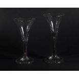 Two 18thC wine glasses, with trumpet bowls and air bubble stems, with folded feet, 18cm and 16.5cm