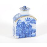 A 18thC blue and white porcelain tea canister and cover, handpainted with buildings and landscape,