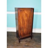 An early 19thC mahogany folio cabinet, the top with a moulded edge above a single panelled door