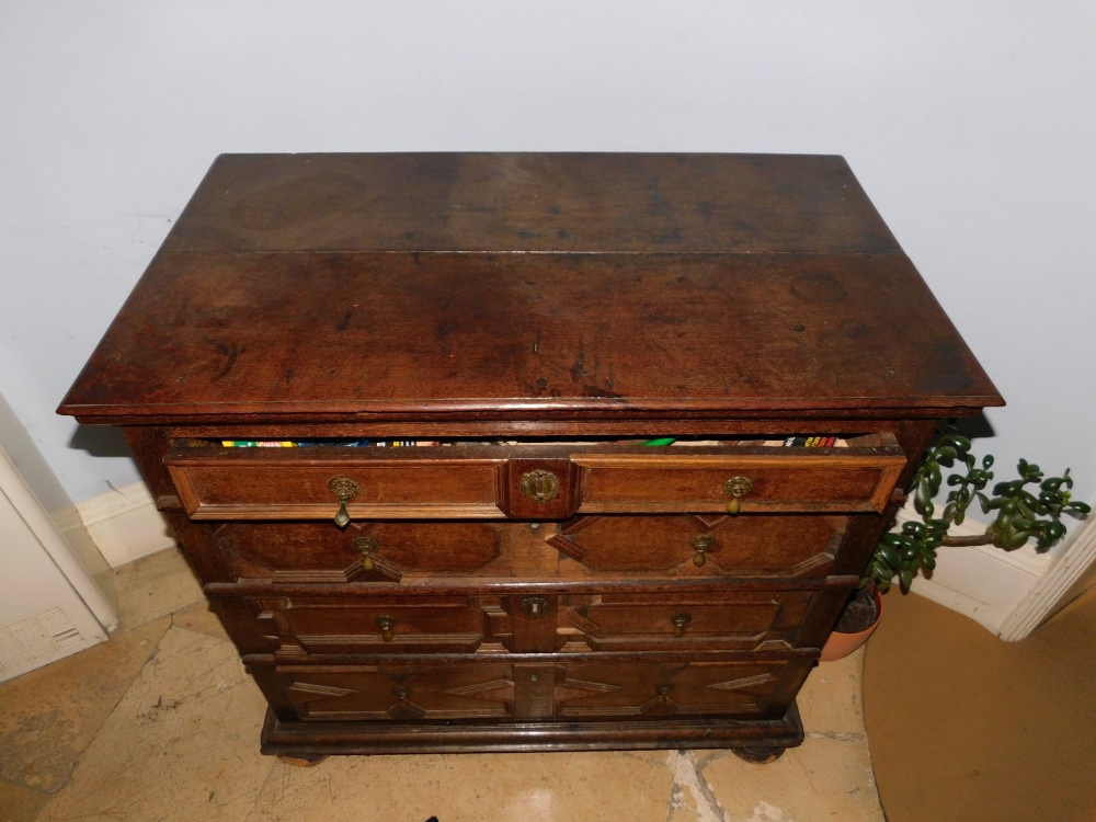 A late 17th/early 18thC oak chest of drawers, the planked top with a moulded edge, above four - Image 2 of 3