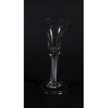 An 18thC wine glass, with bell shaped bowl and air twist stem on a folded foot, 18.5cm high.