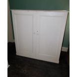 A Victorian painted pine two door press cupboard, 126cm high, 124cm wide, 54cm deep.