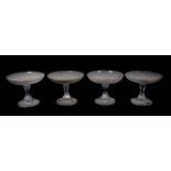 A set of four Victorian glass tazzae, with shallow frosted bowls having Greek Key borders, supported