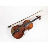 A 19thC German violin, with two piece back and rosewood pegs, (lacking bridge), bears a label to the