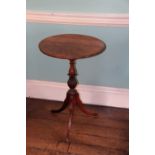 An early 19thC mahogany tripod table, with circular top, acanthus carved pillar on three downswept