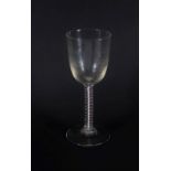 A large 18thC wine glass, with round funnel bowl on a double opaque twist stem, 21cm high.