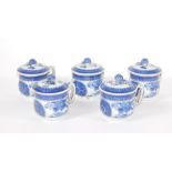 Five early 19thC Chinese consomme cups and covers, decorated in blue and white and having double