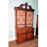 A George III mahogany secretaire bookcase, the associated top with a swan neck pediment central