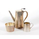 An Edwardian silver three piece coffee set, of plain tapering cylindrical design, London 1902,