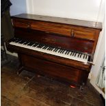 John Broadwood and Sons London. A upright piano in a rosewood case mounted with candle arms (lacking