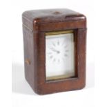 An early 20thC brass cased carriage clock, with moulded case and fluted corners, with a white