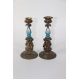 A pair of late 19thC ormolu figural candlesticks, with urn shaped sconces (one lacking) and