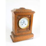 An Edwardian eight day mantel clock, with white enamel and blue painted circular dial, having Arabic