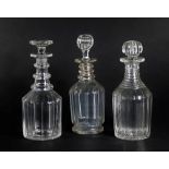 Three Georgian mallet shaped glass decanters, with ring necks and cut bodies, all with stoppers,
