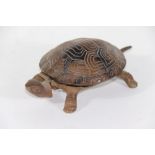 An early 20thC mechanical cast iron tortoise counter top bell, with clockwork movement, stamped GSS,