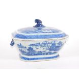 An 18thC Chinese blue and white porcelain tureen and cover, decorated with pagodas, bridge and