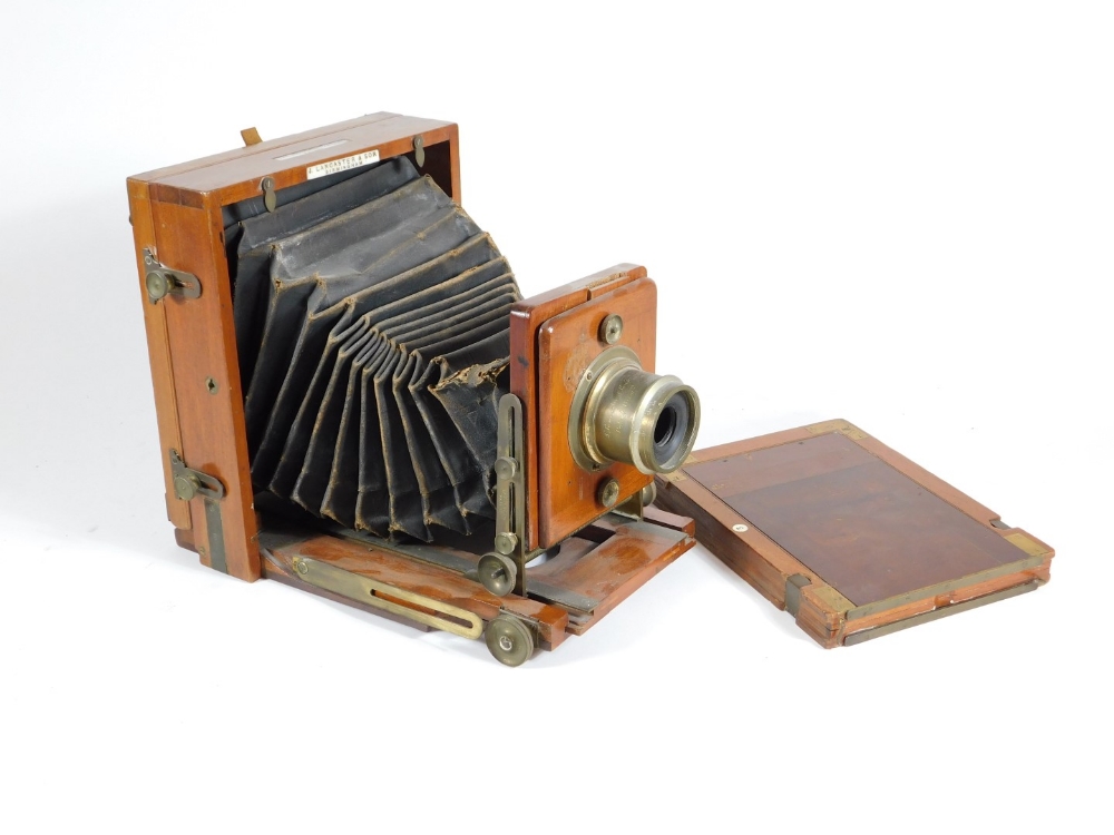 A late Victorian mahogany folding plate camera by J Lancaster and Son Birmingham, having brass