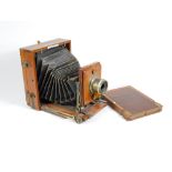 A late Victorian mahogany folding plate camera by J Lancaster and Son Birmingham, having brass