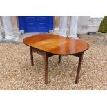 A 19thC mahogany drop leaf table, the top with rounded corners on chamfered legs, 71cm high, 99cm