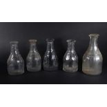 Four similar Regency ring neck table decanters of mallet shaped design, with slice cut shoulders,