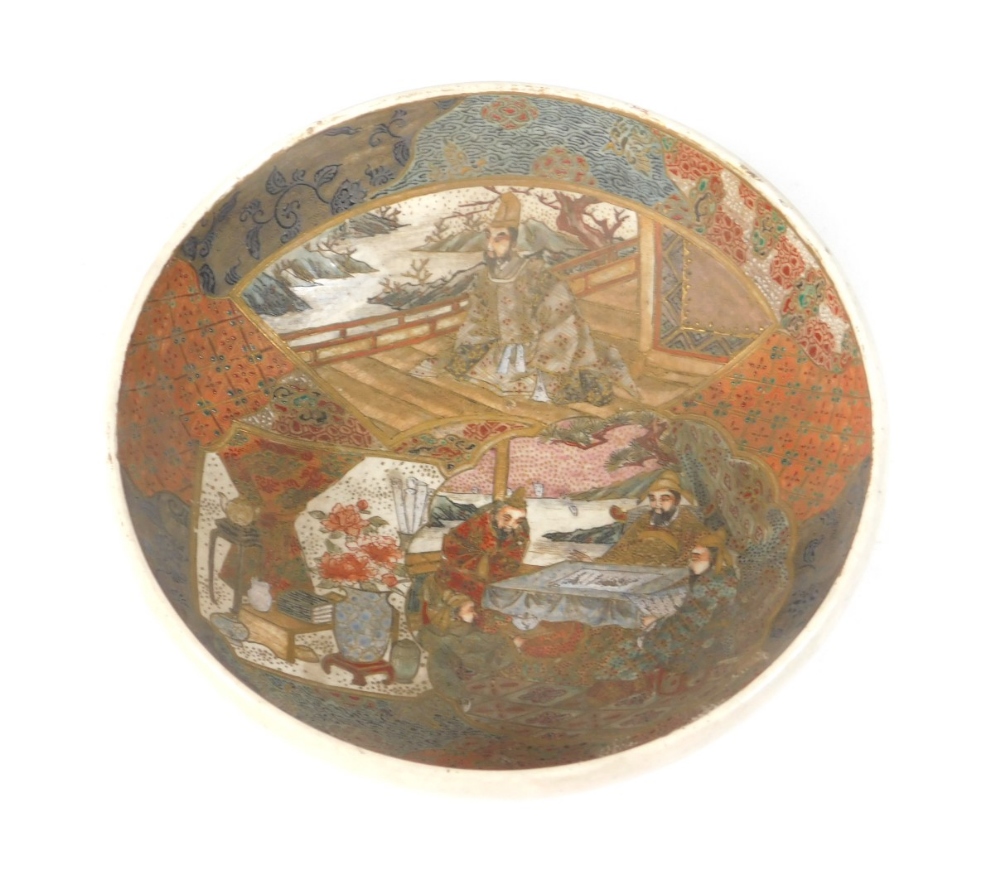 A Japanese Satsuma bowl, decorated with figures, vases in an interior scene, swirl mark to base,