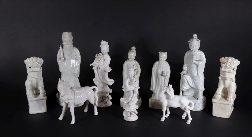 A group of 19thC and later Chinese Blanc De Chine figures, of temple dogs, horses and court figures,