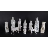 A group of 19thC and later Chinese Blanc De Chine figures, of temple dogs, horses and court figures,