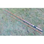 A mid 20thC two piece fibreglass salmon spinning rod, with bag.